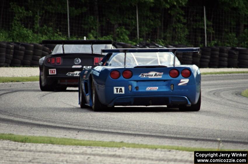 Jordan Bupp's Chevy Corvette chases Tom West's Ford Mustang through the carousel