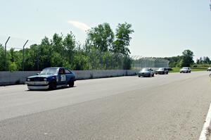 Four cars come through turn 10 during a yellow flag