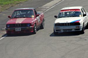 Missing Link Motorsport BMW 325 (left) gets passed by the Tubby Butterman Racing BMW 325