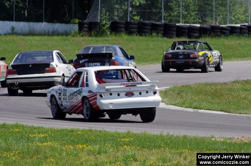 Five cars exit the carousel