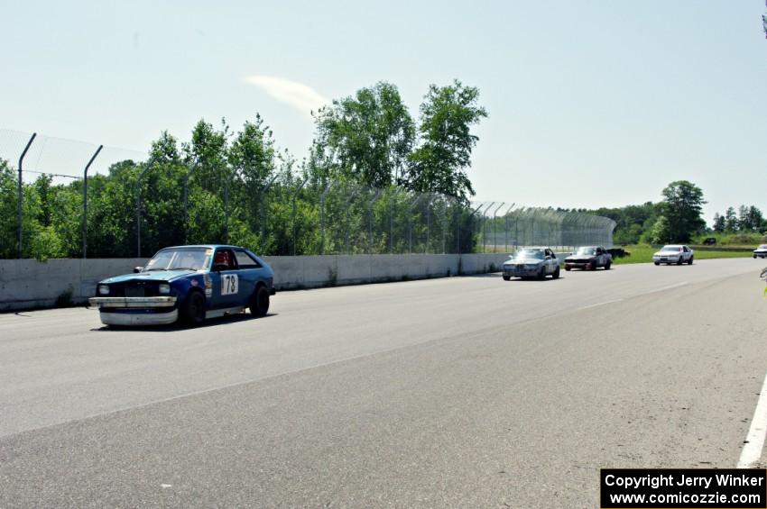 Four cars come through turn 10 during a yellow flag