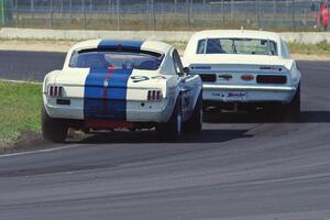 Shannon Ivey's Chevy Camaro leads Brian Kennedy's Ford Shelby GT350 at turn 4