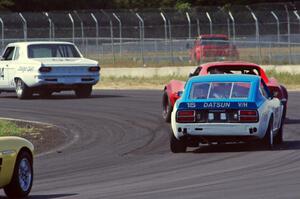 Gary Davis's Dodge Dart, Phil Neal's Chevy Corvette and Joe Tessmer's Datsun 240Z at turn 4