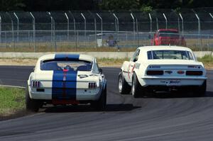 Shannon Ivey's Chevy Camaro leads Brian Kennedy's Ford Shelby GT350 at turn 4