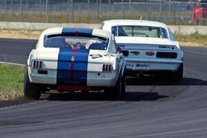 Shannon Ivey's Chevy Camaro leads Brian Kennedy's Ford Shelby GT350 at turn 4