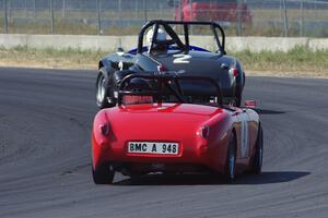 Phil Schaefer's Austin-Healey Sprite leads Tom Daly's Austin-Healey Sprite through turn 4