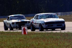 Shannon Ivey's Chevy Camaro leads Brian Kennedy's Ford Shelby GT350 into turn 4