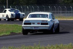 Shannon Ivey's Chevy Camaro chases Brian Kennedy's Ford Shelby GT350 at turn 4
