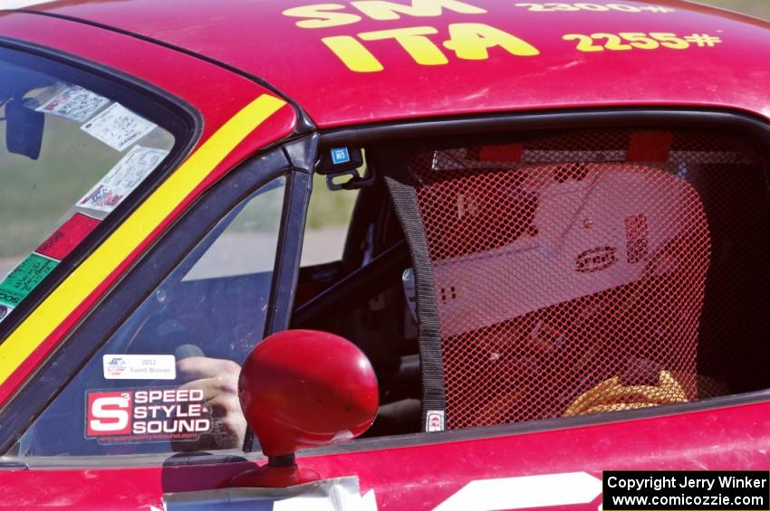 Greg Youngdahl sits in his Spec Miata Mazda Miata