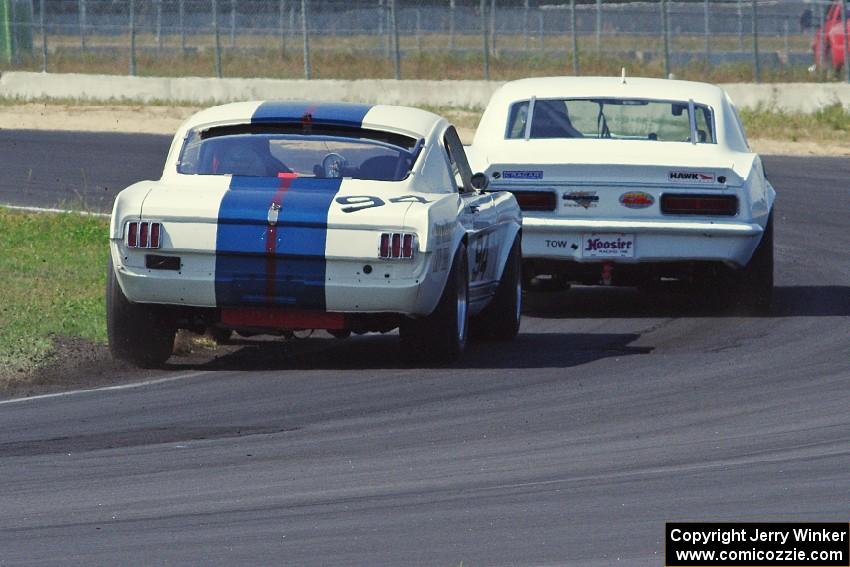 Shannon Ivey's Chevy Camaro leads Brian Kennedy's Ford Shelby GT350 at turn 4