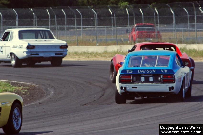 Gary Davis's Dodge Dart, Phil Neal's Chevy Corvette and Joe Tessmer's Datsun 240Z at turn 4