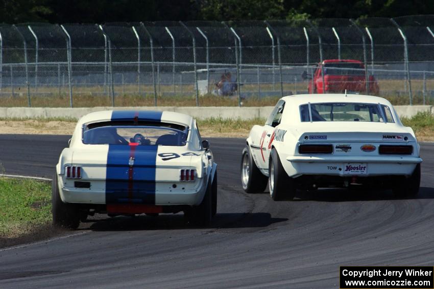 Shannon Ivey's Chevy Camaro leads Brian Kennedy's Ford Shelby GT350 at turn 4