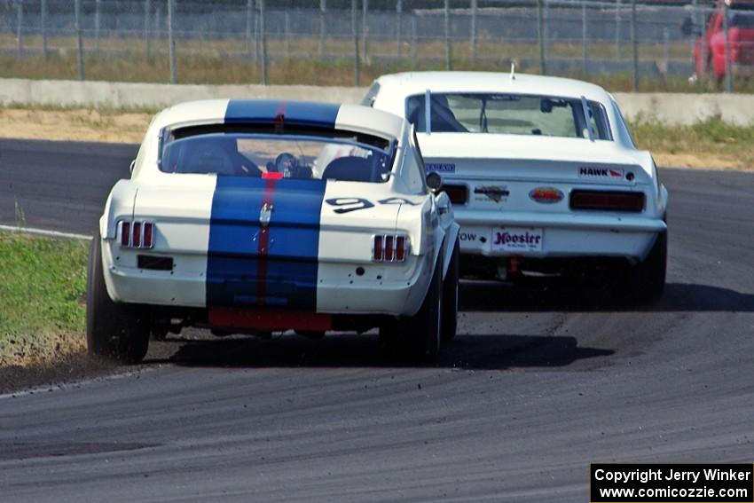 Shannon Ivey's Chevy Camaro leads Brian Kennedy's Ford Shelby GT350 at turn 4