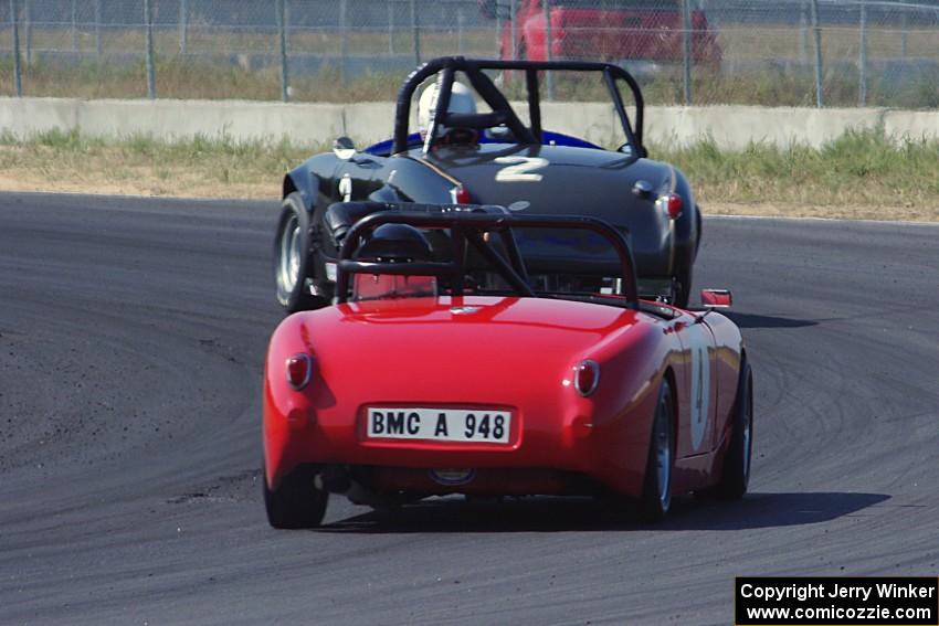 Phil Schaefer's Austin-Healey Sprite leads Tom Daly's Austin-Healey Sprite through turn 4