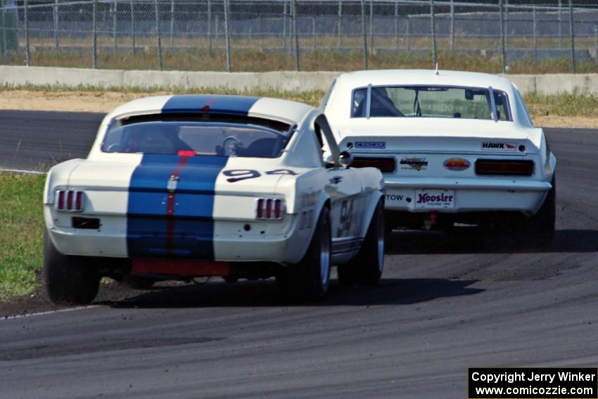 Shannon Ivey's Chevy Camaro leads Brian Kennedy's Ford Shelby GT350 at turn 4