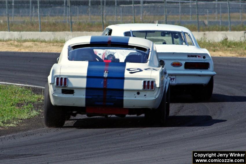 Shannon Ivey's Chevy Camaro leads Brian Kennedy's Ford Shelby GT350 at turn 4