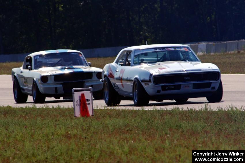 Shannon Ivey's Chevy Camaro leads Brian Kennedy's Ford Shelby GT350 into turn 4