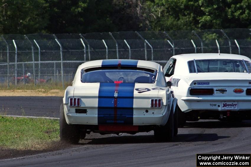 Shannon Ivey's Chevy Camaro leads Brian Kennedy's Ford Shelby GT350 into turn 4