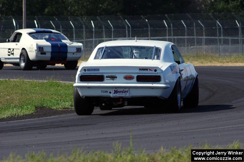 Shannon Ivey's Chevy Camaro chases Brian Kennedy's Ford Shelby GT350 at turn 4