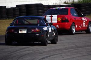 Paul Gilbert's Spec Miata Mazda Miata chases John Glowaski's ITA Dodge Neon ACR