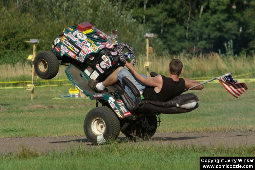 An animal in the infield of BIR rides a wheelie on his riding lawnmower.