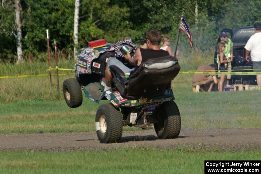 An animal in the infield of BIR rides a wheelie on his riding lawnmower.