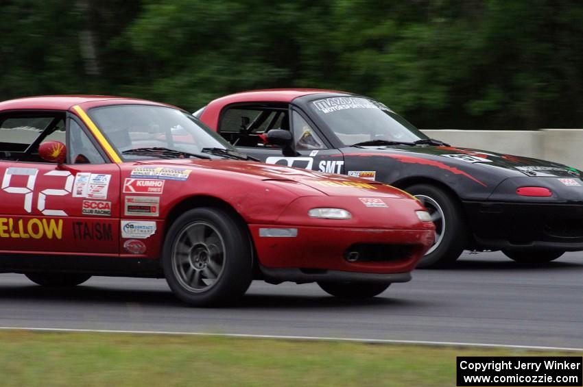 Greg Youngdahl's Spec Miata Mazda Miata passes Chris Bienert's Spec Miata Mazda Miata