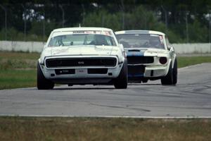 Shannon Ivey's Chevy Camaro leads Brian Kennedy's Ford Shelby GT350 into turn 12