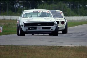 Shannon Ivey's Chevy Camaro leads Brian Kennedy's Ford Shelby GT350 into turn 12
