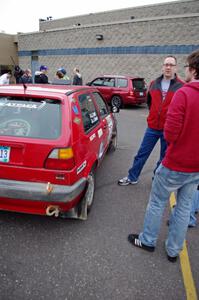 John Kimmes talks to a rally fan next to the VW GTI he shares with Greg Smith.