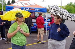 Amanda Ingle and Amy Springer wait out the sprinkles during Rallyfest.