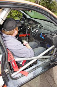 Ben Slocum sits on the freshly-repaired side of the Ford Focus he and Dillon Van Way shared.