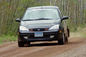 The Pawel Dubina / Karol Dubina Ford Focus at speed on stage one.