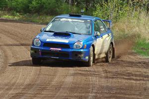 Janusz Topor / Michal Kaminski power their Subaru WRX STi through a sweeper on stage two.