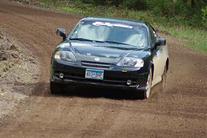 The Derek McCorison / Paul Johansen Hyundai Tiburon drifts through a sweeper on stage two.