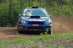 Janusz Topor / Michal Kaminski drift through a sweeper on stage three in their Subaru WRX STi.