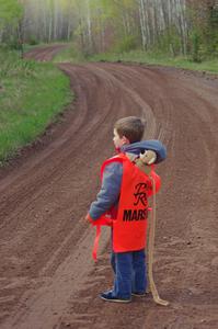 A young marshal awaits the start of stage four.
