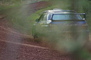 Janusz Topor / Michal Kaminski drift their Subaru WRX STi through a sweeper on stage four.