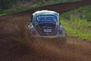 The Mark Huebbe / John Huebbe VW Beetle slings gravel at an uphill sweeper on stage four.