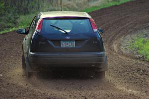 The Pawel Dubina / Karol Dubina Ford Focus drifts through a sweeper on stage four.