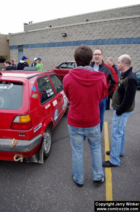 John Kimmes talks to rally fans next to the VW GTI he shares with Greg Smith.