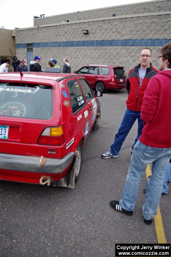 John Kimmes talks to a rally fan next to the VW GTI he shares with Greg Smith.