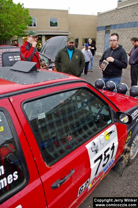 John Kimmes talks to Pete Winters and Breon Nagy next to the VW GTI he shares with Greg Smith.