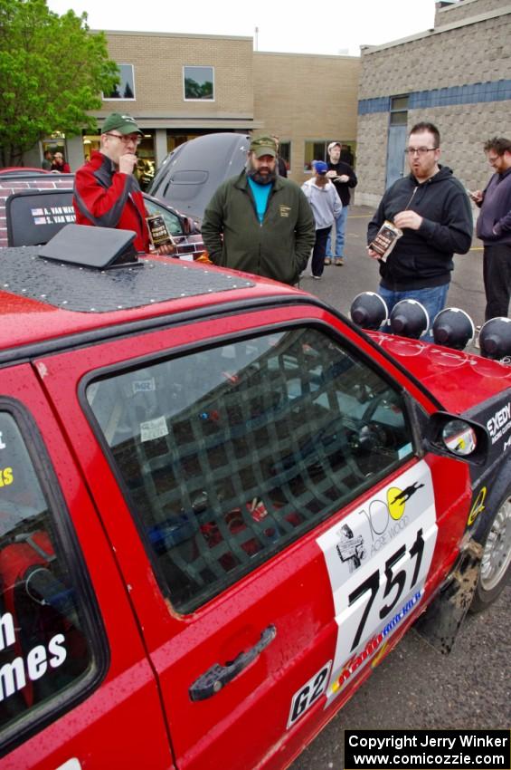 John Kimmes talks to Pete Winters and Breon Nagy next to the VW GTI he shares with Greg Smith.