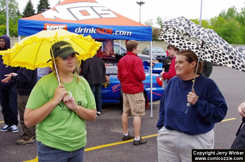 Amanda Ingle and Amy Springer wait out the sprinkles during Rallyfest.