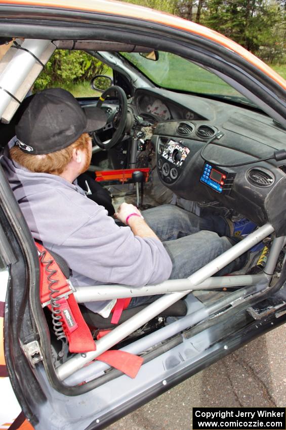 Ben Slocum sits on the freshly-repaired side of the Ford Focus he and Dillon Van Way shared.