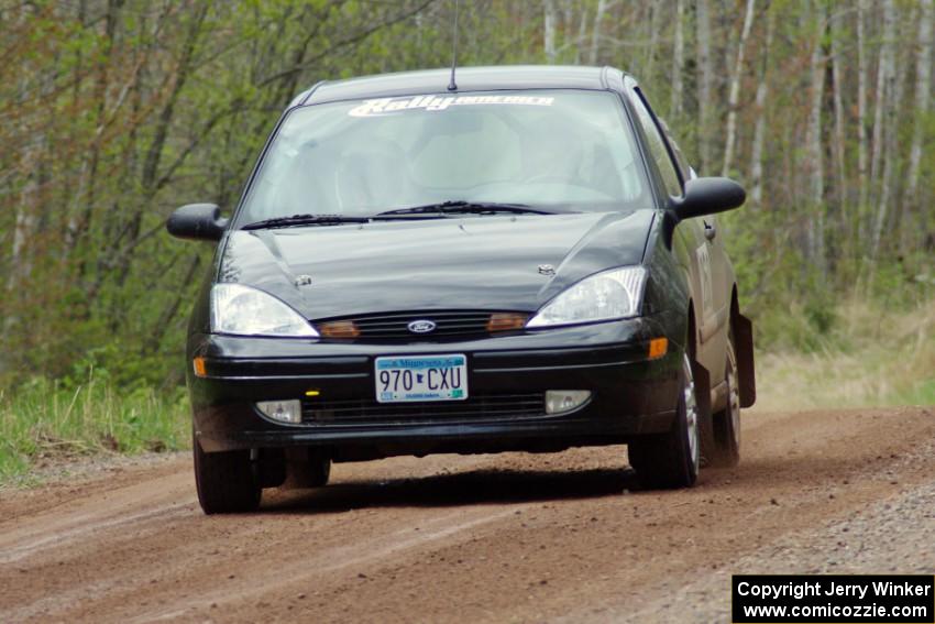 The Pawel Dubina / Karol Dubina Ford Focus at speed on stage one.