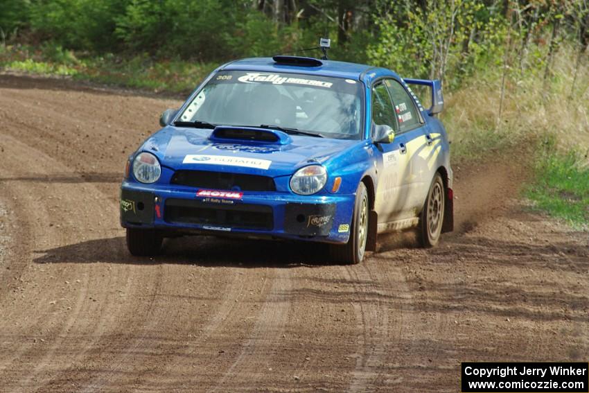 Janusz Topor / Michal Kaminski power their Subaru WRX STi through a sweeper on stage two.