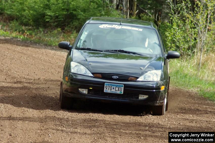 Pawel Dubina / Karol Dubina drift their Ford Focus through a sweeper on stage two.