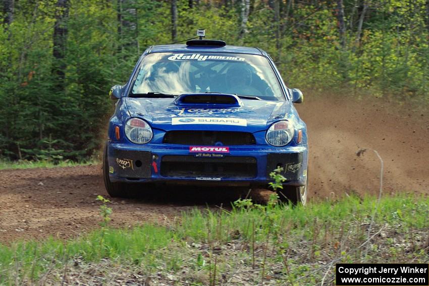 Janusz Topor / Michal Kaminski drift through a sweeper on stage three in their Subaru WRX STi.